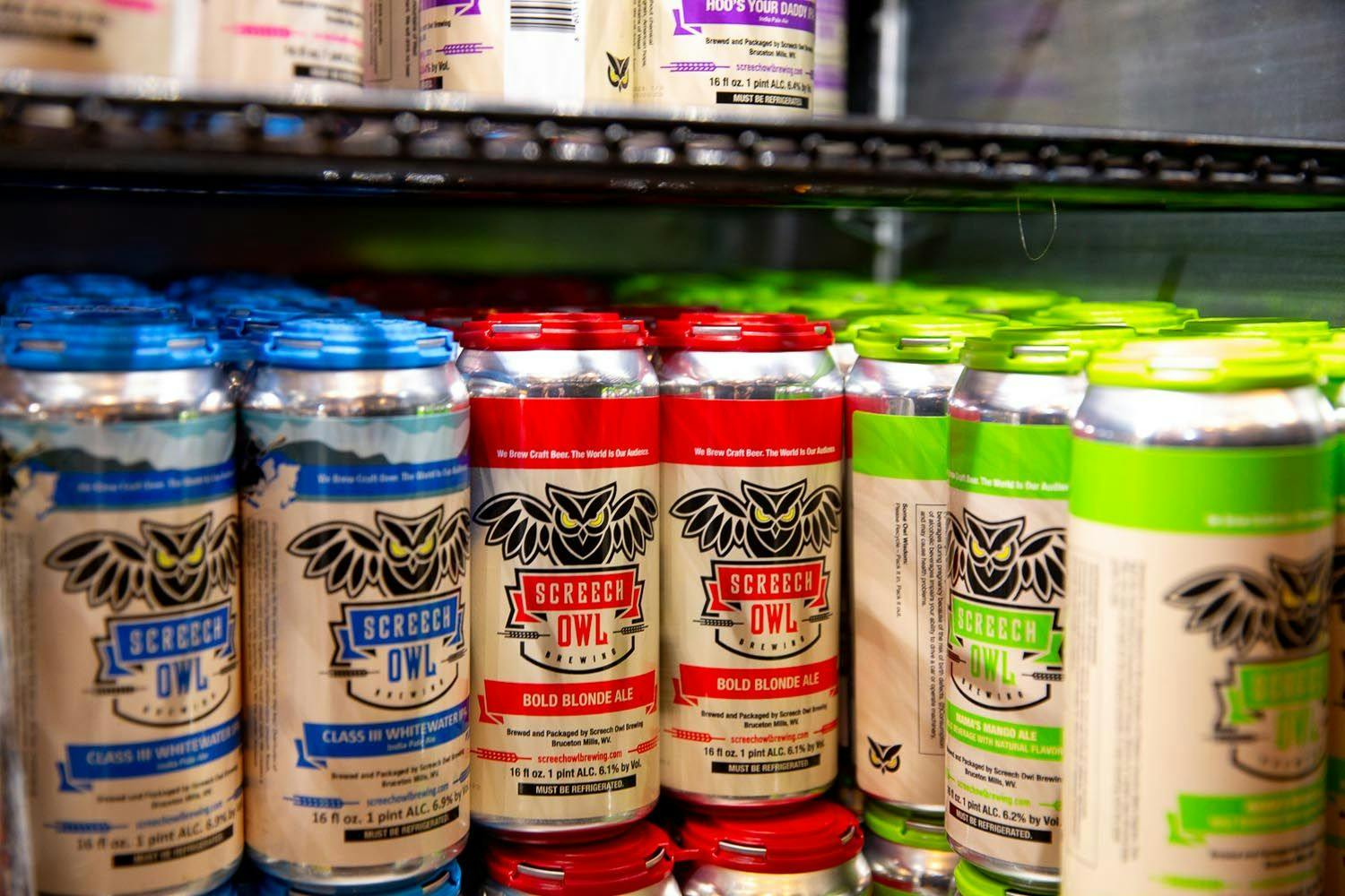 A variety of Screech Owl beer cans